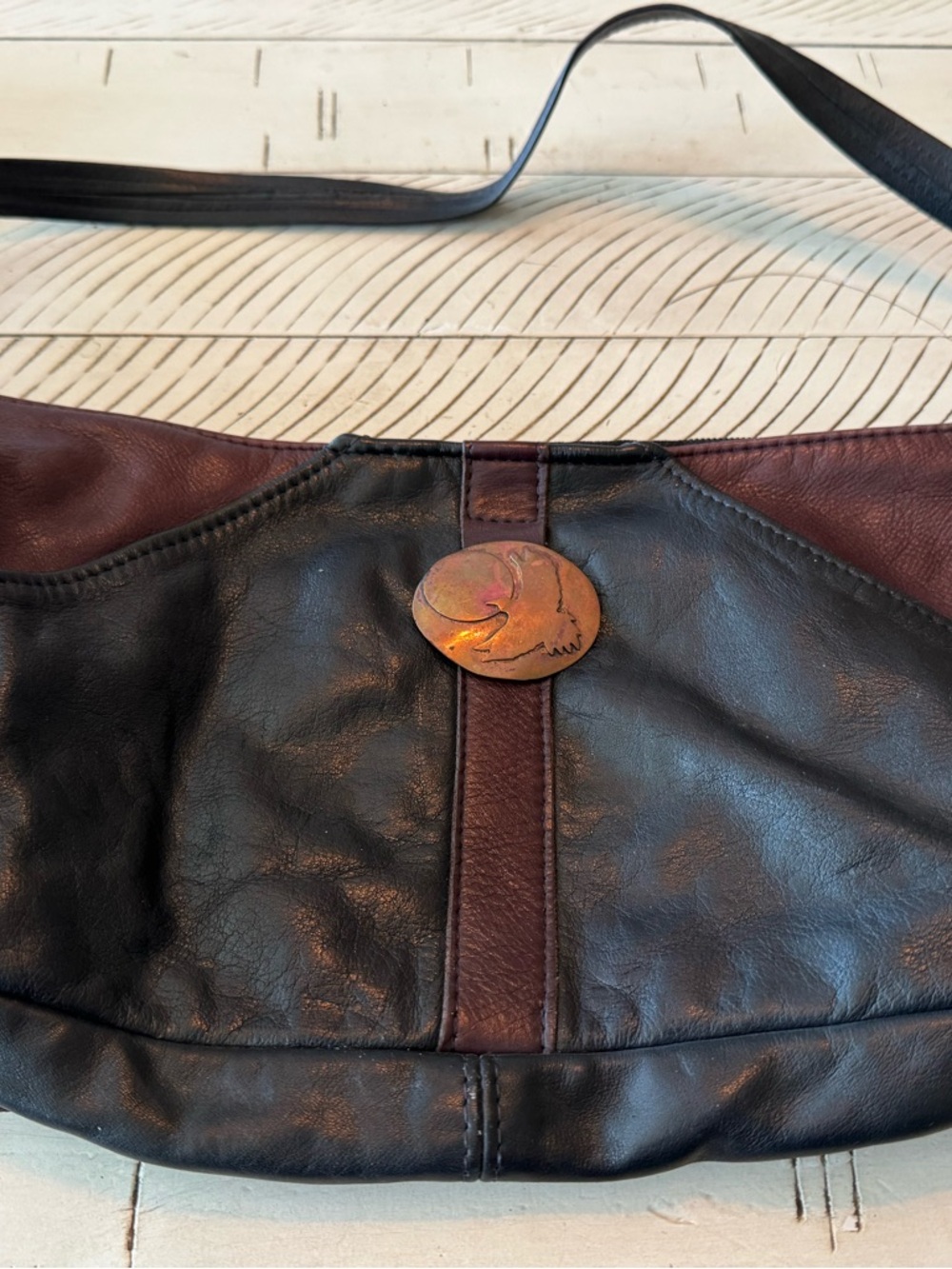 Used Black and Brown Leather Shoulder Bag with Decorative Medallion